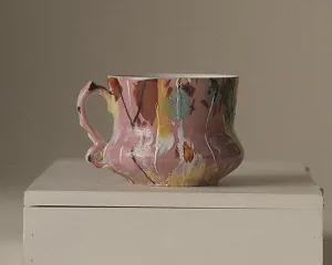 A hand-painted teacup shown with its provenance note in Ethereal